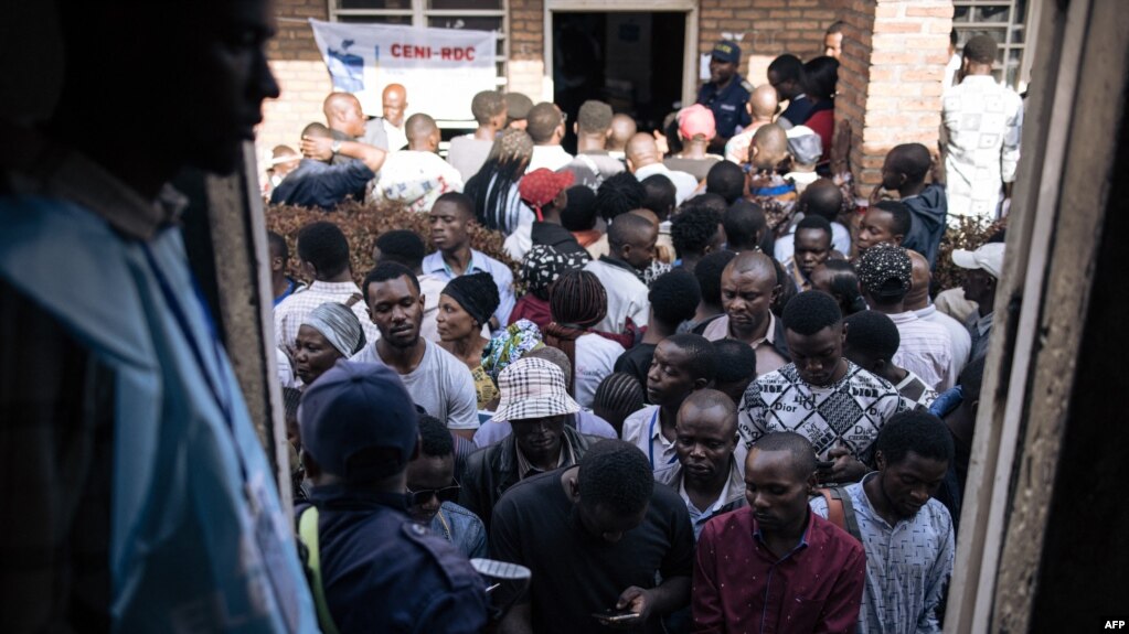 Voters queue outside the polling station at the Institut Zanner in Goma on December 20, 2023.