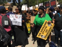 Female demonstrators sing and chant slogans protesting violence against women in Sandton, Johannesburg, Sept. 13, 2019. (T.Khumalo/VOA)