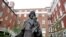 FILE - A Jesuit statue is seen in front of Freedom Hall, formerly named Mulledy Hall, on the Georgetown University campus in Washington, September 2016. The U.S.-based branch of the Jesuits has unveiled ambitious plans for a “truth and reconciliation” ini