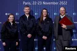 Anggota astronot kelas baru ESA Meganne Christian, John McFall dan Rosemary Coogan berpose bersama Menteri Luar Negeri Inggris di Departemen Bisnis, Energi dan Strategi Industri George Freeman di Grand Palais Ephemere di Paris , Prancis, 23 November 2022. (Benoit Tessier/REUTERS)