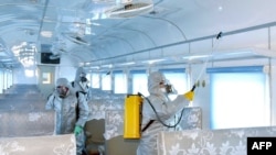 A trolley bus is disinfected amid fears over the spread of the novel coronavirus in Pyongyang, North Korea, Feb. 22, 2020, and released by Kyodo on Feb. 23, 2020.