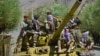 TOPSHOT - Afghan resistance movement and anti-Taliban uprising forces are pictured on a Soviet-era tank as they are deployed to patrol along a road in the Astana area of Bazarak in Panjshir province on August 27, 2021, as among the pockets of…