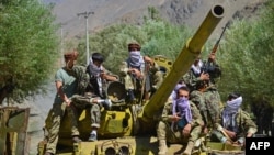 TOPSHOT - Afghan resistance movement and anti-Taliban uprising forces are pictured on a Soviet-era tank as they are deployed to patrol along a road in the Astana area of Bazarak in Panjshir province on August 27, 2021, as among the pockets of…
