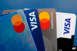 FILE - Credit cards are displayed on July 1, 2021, in Orlando, Fla. The jump in bond yields is raising the costs of consumer and business borrowing, including mortgages, auto loans and credit card debt. (AP Photo/John Raoux, File)