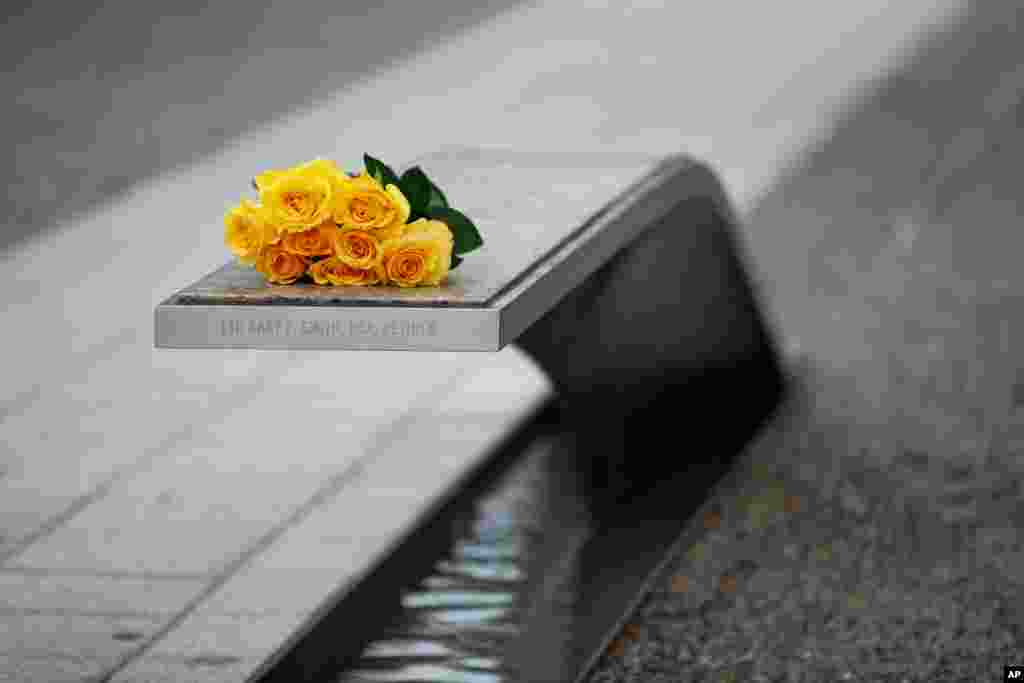 Flowers rest on a bench bearing a name in memory of retired U.S. Army Lieutenant Colonel Gary Smith before a ceremony in observance of the 18th anniversary of the 9/11 attacks at the Pentagon in Washington, Sept. 11, 2019.