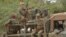 Malian soldiers patrol aboard a vehicle mounted with a machine gun in a street of Diabaly (400km north of the capital Bamako), January 26, 2013. 