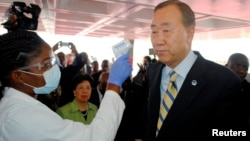 U.N. Secretary General Ban Ki-moon has his temperature checked upon arrival at the Roberts International airport in Liberia's capital Monrovia, Dec. 19, 2014. 