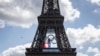 (FILES) A French national flag flutters on the Eiffel Tower behind the Olympic rings following a ceremony commemorating the firemen who raised the French flag on the Eiffel Tower in 1944 after Paris was liberated from the Nazi occupation, in Paris on Augu