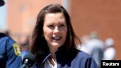 FILE - Michigan Governor Gretchen Whitmer addresses the media in downtown Midland, Michigan, May 20, 2020.