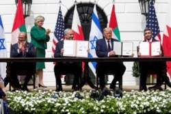 Bahrain’s FM Abdullatif al-Zayani, Israel's PM Benjamin Netanyahu, U.S. President Donald Trump and United Arab Emirates (UAE) FM Abdullah bin Zayed participate in the signing of the Abraham Accords, at the White House, Sept. 15, 2020.