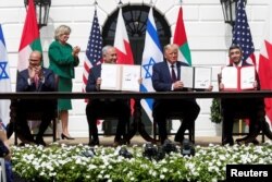 FILE - Bahrain’s FM Abdullatif al-Zayani, Israel's PM Benjamin Netanyahu, US President Donald Trump and United Arab Emirates (UAE) FM Abdullah bin Zayed participate in the signing of the Abraham Accords, at the White House, Sept. 15, 2020.