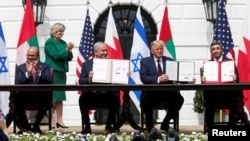 Bahrain’s FM Abdullatif al-Zayani, Israel's PM Benjamin Netanyahu, US President Donald Trump and United Arab Emirates (UAE) FM Abdullah bin Zayed participate in the signing of the Abraham Accords, at the White House, Sept. 15, 2020.