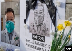 The Chinese student and his supporters hold a memorial for Dr. Li Wenliang, the whistleblower of the coronovirus, Kovid-19, which originated in Wuhan, China.