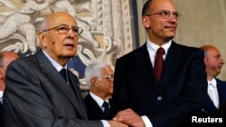Italian Prime Minister-designate and deputy leader of the centre-left Democratic Party (PD) Enrico Letta (R) shakes hands with President Giorgio Napolitano at the Quirinale Palace in Rome, April 27, 2013. 