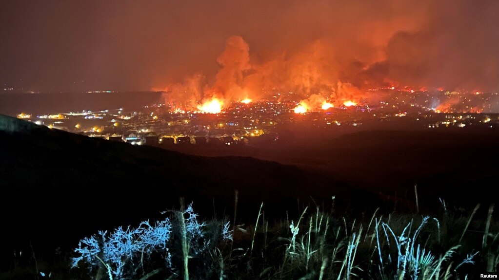 Buildings burn as a wind-driven grass fire destroys hundreds of homes, displaces thousands, as seen from Denver, Colorado, U.S. December 30, 2021. (Gregg Corella/Handout via REUTERS)