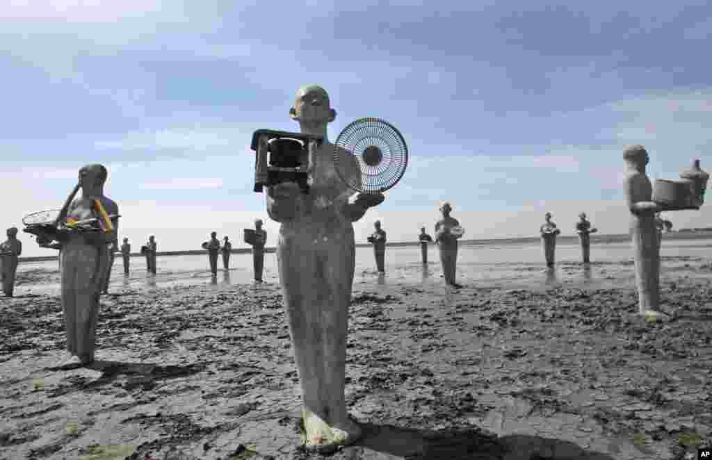 Statues, called &quot;Survivors&quot; created by Indonesian artist Dadang Christanto, are erected at the site that has been overwhelmed by mud oozing from a mud volcano, in Porong, East Java, Indonesia. The statues were installed to commemorate the 8th year since the mud volcano.