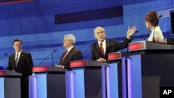 Republican presidential candidates (L-R) former Massachusetts Gov. Mitt Romney, former House Speaker Newt Gingrich, Rep. Ron Paul, and Rep. Michele Bachmann, participate in a Republican presidential debate in Sioux City, Iowa, December 15, 2011