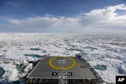 FILE - The Finnish icebreaker MSV Nordica sails through sea ice floating on the Victoria Strait along the Northwest Passage in the Canadian Arctic Archipelago, July 21, 2017.