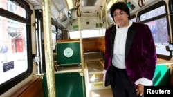 Cloyd Thomas, a Cleveland regional Transit Authority Trolley driver poses as Prince inside his trolley as part of the Rock and Roll Hall of Fame Induction week in Cleveland, Ohio, April 15, 2015. 