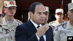 FILE - In this photo provided by Egypt's state news agency MENA, President Abdel Fattah el-Sissi speaks in front of the state-run TV in Cairo, Oct. 25, 2014. 