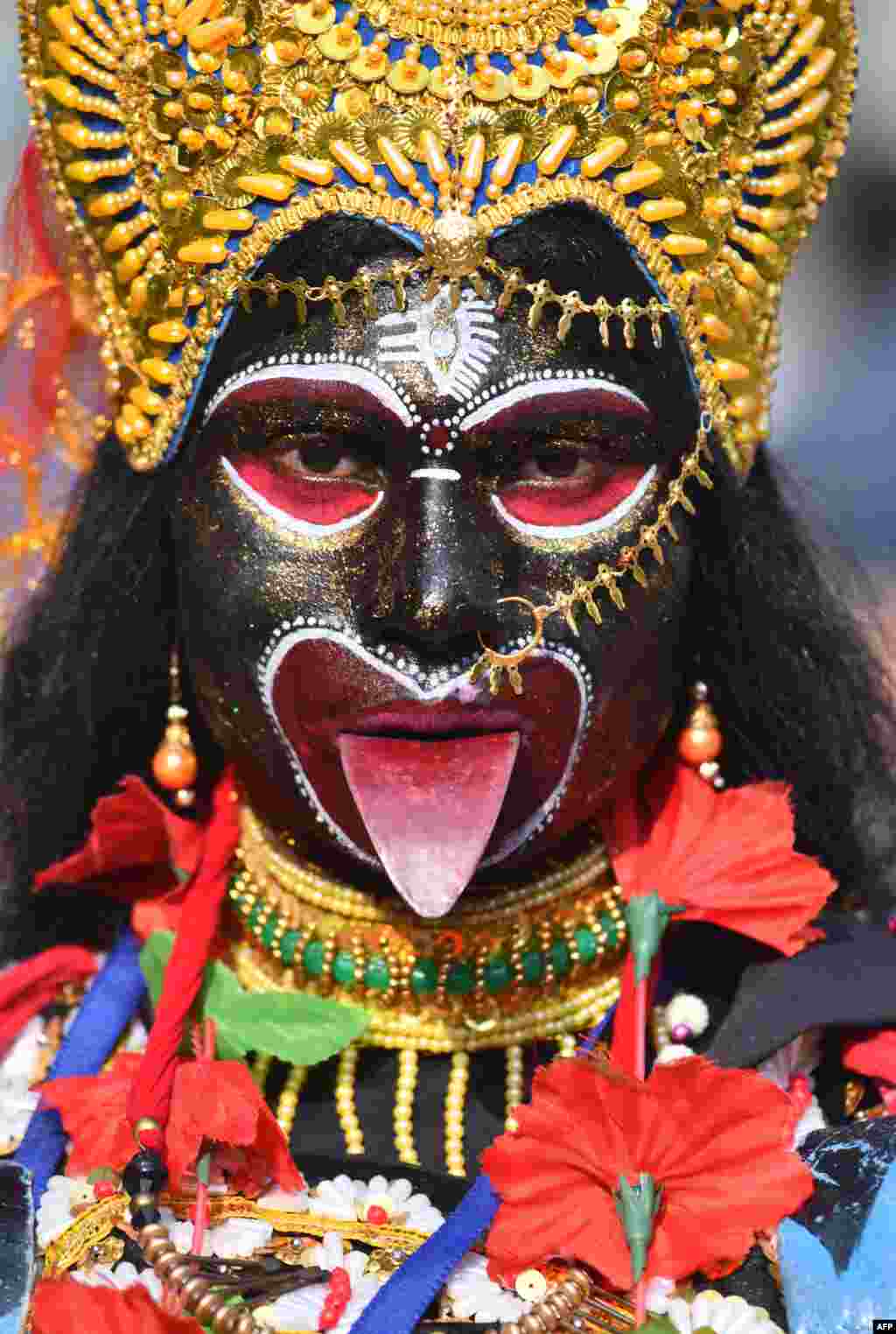 An Indian devotee dressed as the Hindu deity Kali attends the annual Ambubachi festival at Kamakhya Temple, in Guwahati. Thousands of devotees from all over India gather on the occasion of the Ambubachi Mela, which is celebrated to mark the yearly menstruation course of goddess Kamakhya.