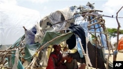 Somalis displaced by fighting between the Somali government and Islamist insurgents are seen in a makeshift home at a camp for internally displaced people on the outskirts of Mogadishu, Somalia (File)