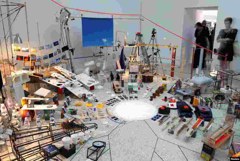 A visitor looks at the installation called "Triple point" by U.S. artist Sarah Sze at the United States pavilion, May 29, 2013.