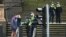Police check details of residents in the Melbourne central business district in Australia's worst-hit Victoria state, Aug. 9, 2020, as the city struggles to cope with COVID-19 pandemic.