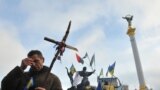 A pro-European protester crosses himself during a religious service on Independence Square in Kyiv. Ukraine&#39;s opposition sat down for talks with President Yanukovych on Friday for the first time since mass protests broke out three weeks ago.