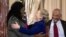 Secretary of State Hillary Rodham Clinton greets Florence Ngobeni-Allen, ambassador for the Elizabeth Glaser Pediatric AIDS Foundation during a ceremony in recognition of World AIDS Day, at the State Department in Washington, D.C., November 29, 2012.