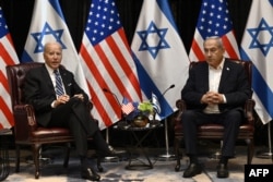 FILE - US President Joe Biden (L) listens to Israel's Prime Minister Benjamin Netanyahu as he joins a meeting of the Israeli war cabinet in Tel Aviv on October 18, 2023, amid the ongoing battles between Israel and the Palestinian group Hamas.