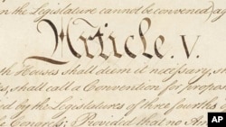 This photo made available by the U.S. National Archives shows a portion of the United States Constitution with the title of Article V. For the past two centuries, constitutional amendments have originated in Congress, where they need the support of two-thirds of both houses, and then the approval of at least three-quarters of the states. But under a never-used second prong of Article V, amendments can originate in the states. 