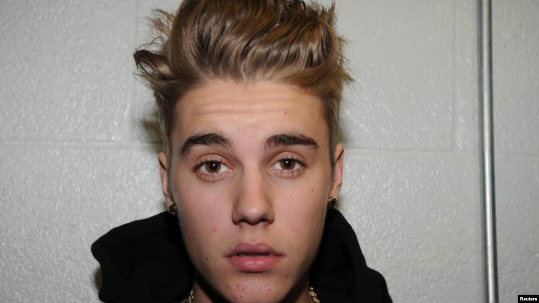 Canadian pop singer Justin Bieber is pictured in police custody in Miami Beach, Florida January 23, 2014 in this Miami Beach Police Department handout released to Reuters on March 4, 2014.