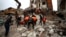Civil defense workers and security forces search through the wreckage of collapsed buildings in Hama, Syria, Feb. 6, 2023. 