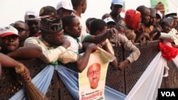 Supporters of Nigerian presidential candidate Muhammadu Buhari hold a campaign poster depicting him on January 19 in Kaduna, Nigeria. (Chris Stein for VOA News)