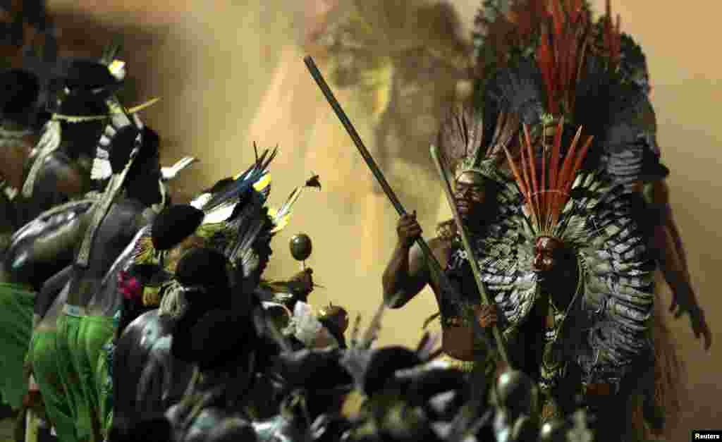 Members of the Brazilian indigenous ethnic group Kuikuro dance before the opening ceremony of the XII Games of the Indigenous People in Cuiaba, Brazil, Nov. 9, 2013.