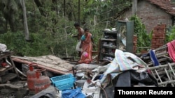 Residents salvage their belongings from the rubble of a damaged house in the aftermath of Cyclone Amphan, in South 24 Parganas, West Bengal, India.