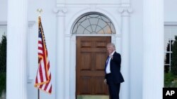 President-elect Donald Trump gives the thumbs-up after Mitt Romney leaves Trump National Golf Club Bedminster in Bedminster, N.J., Nov. 19, 2016. 