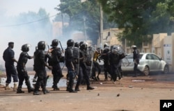 FILE - Mali's riot security forces battle with opposition activists during a prohibited march in Bamako, Mali, June 2, 2018.