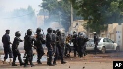 FILE - Mali's riot security forces battle with opposition activists during a prohibited march in Bamako, Mali, June 2, 2018. Government administrators organizing next month's presidential election launched a seven-day strike Monday demanding more security.