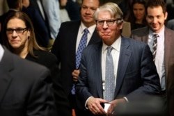 Manhattan District Attorney Cyrus Vance Jr., foreground right, accompanied by Assistant District Attorney Joan Illuzzi, leaves the courtroom after Harvey Weinstein's rape trial adjourned for the day, in New York, Feb. 21, 2020.