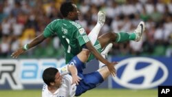 Challenged by Nigeria's Ahmed Musa, top, England's Billy Knott falls down after kicking a ball that rattled the crossbar during a U-20 World Cup round of 16 soccer match in Armenia, Colombia. Nigeria won 1-0.