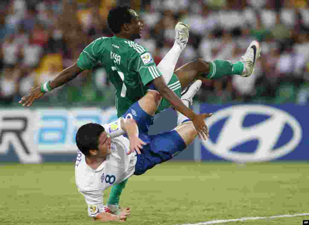 Challenged by Nigeria's Ahmed Musa, top, England's Billy Knott falls down after kicking a ball that rattled the crossbar during a U-20 World Cup round of 16 soccer match in Armenia, Colombia. Nigeria won 1-0.