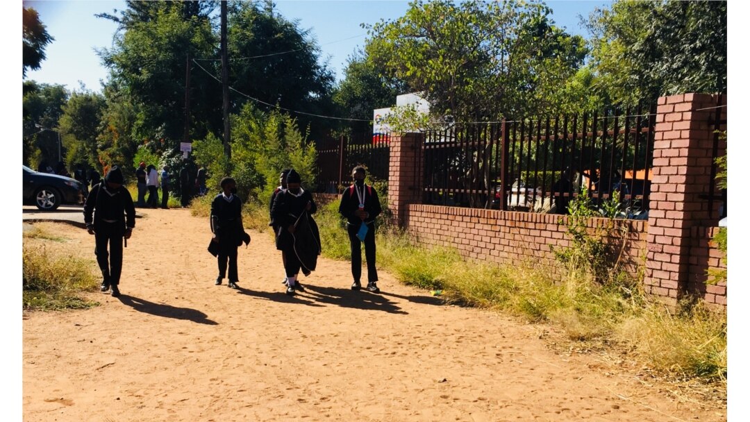 Students walk near a school as classes are cancelled in response to a surge of new COVID-19 cases, in Gaborone, Botswana. (Mqondisi Dube/VOA)