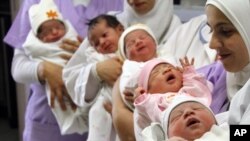 Nurses hold newborn babies in Sidon, Lebanon, Oct. 31, 2011. 