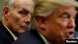 FILE - Homeland Security Secretary John Kelly (L) listens to U.S. President Donald Trump during a meeting with cyber security experts in the Roosevelt Room of the White House in Washington, U.S., January 31, 2017. 