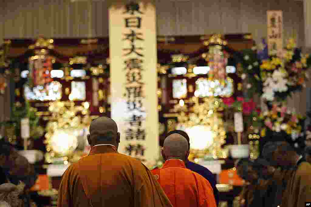 Monks enter the main hall for a memorial service for the March 11 earthquake and tsunami victims at Flora Memorial Hall in Soma, Fukushima Prefecture, April 28, 2011. (AP)