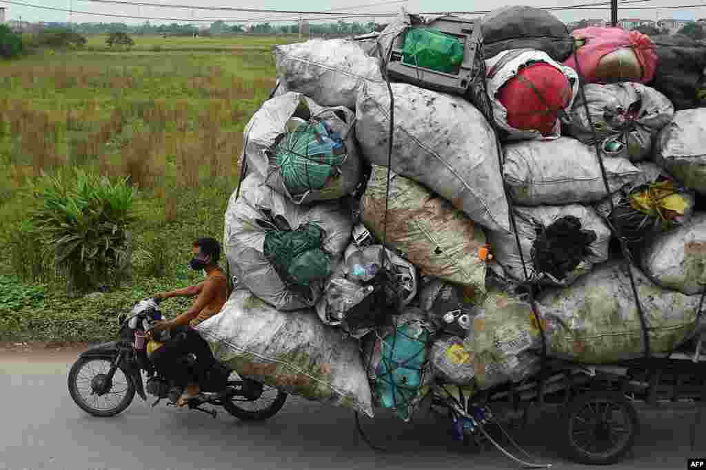 Waste collectors transport plastic scrap for recycling in the suburbs of Hanoi, Vietnam, Oct. 15, 2019.