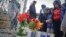 Rev. Kirsten Foy, National Action Network's north east regional director, center, with his sons, Seth, 7, far right, and and Samuel, 5, second from right, pray at a memorial, April 5, 2018, in New York, where Saheed Vassell was shot. 