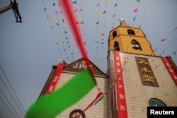 A man decorates a government-sanctioned Catholic church a day before Easter in Youtong village, Hebei province, China, March 31, 2018.